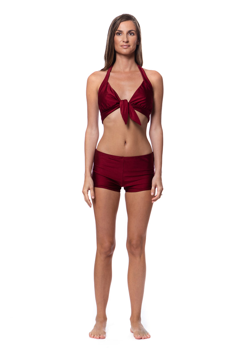 Bella Paradise designer resort wear swim bottoms in deep red with matching halter top on model