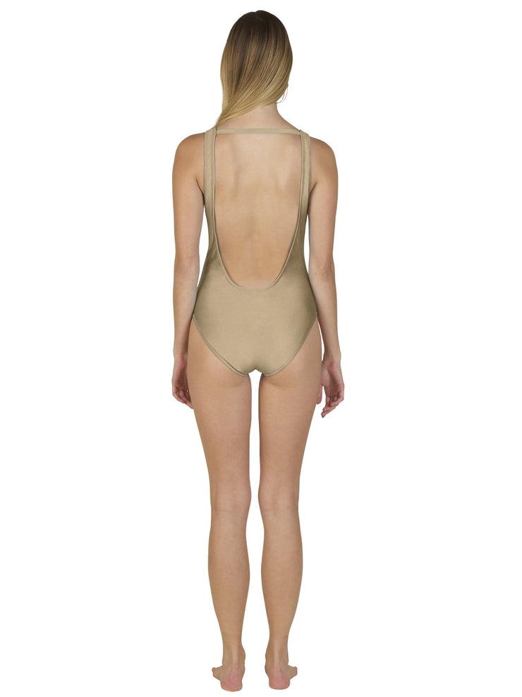 Back view of model wearing Bella Paradise luxury one piece swimsuit in beige with low scoop back
