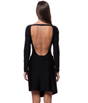 Back view of a woman wearing a black open-back swimsuit, showcasing the luxury resort skirt style by Bella Paradise