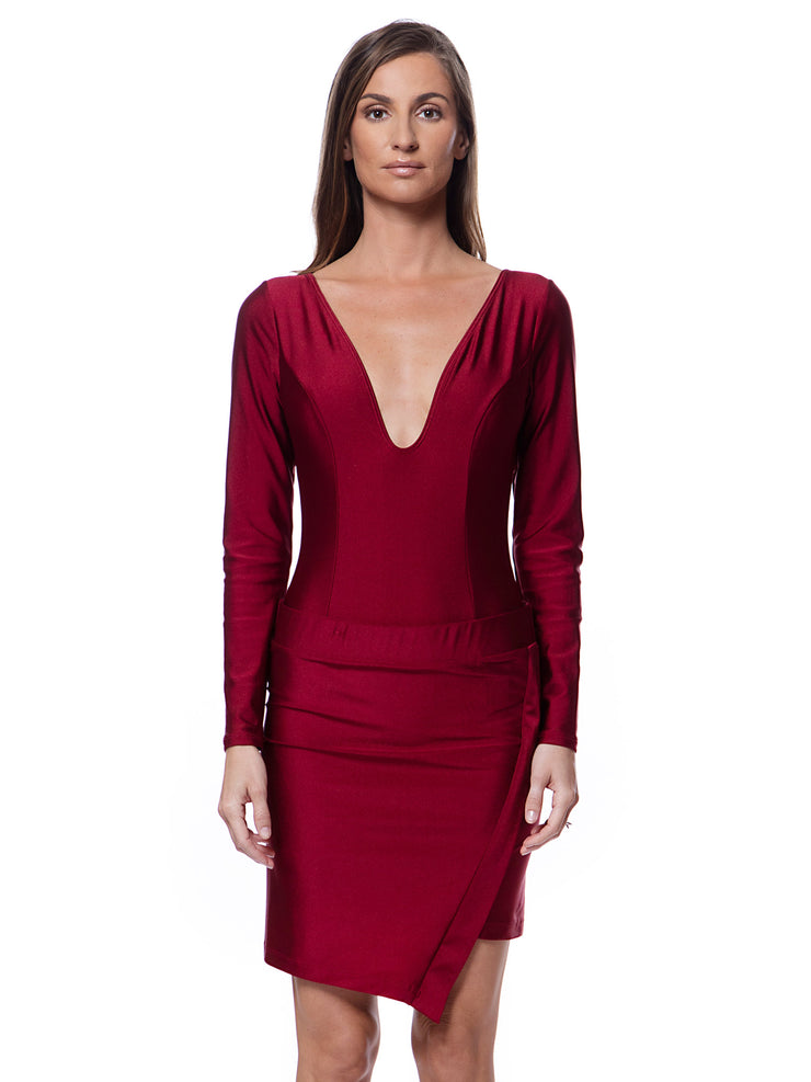 Woman wearing a red luxury resort skirt dress with long sleeve swimsuit with deep V neckline by Bella Paradise