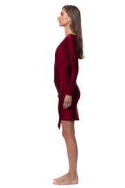 Side view of woman wearing a cardinal red luxury resort skirt by Bella Paradise