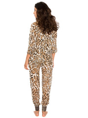 Back view of woman wearing resort woven leopard cover up pants for women by Bella Paradise
