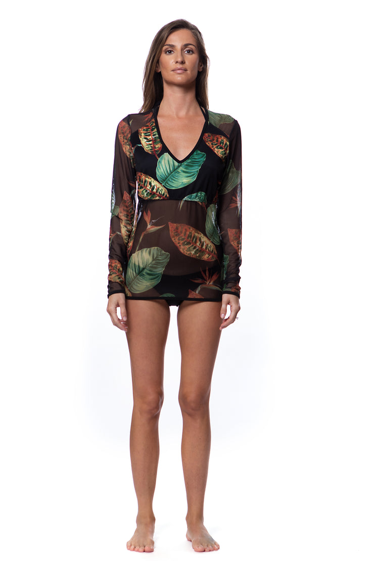 Bella Paradise long sleeve tropical rash guard with vibrant green and brown leaf print on model