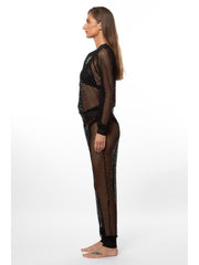 Side view of a woman wearing a black luxury mesh bomber jacket and matching pants by Bella Paradise