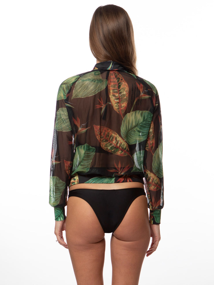 Back view of woman wearing Bella Paradise tropical print mesh bomber with green leaf design